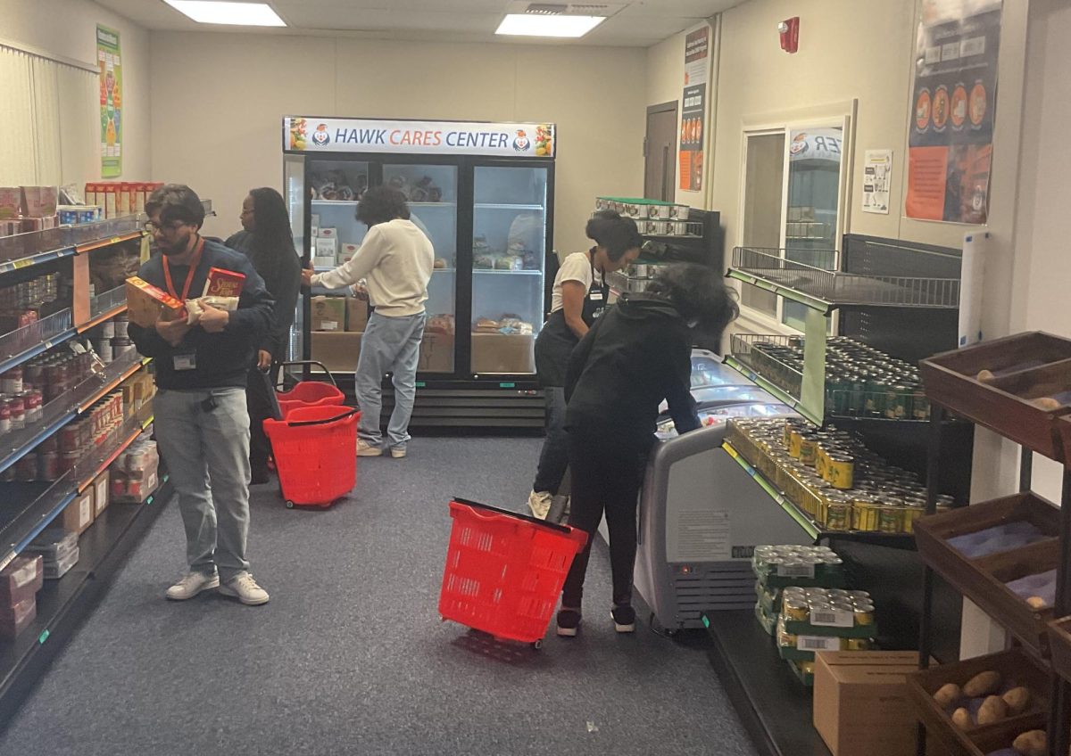 Students and Hawk CARES center staff in The Market on Nov 17. Located in portable 48, The Market provides free food assistance for students enrolled in three or more units and who have CRC as their home campus.