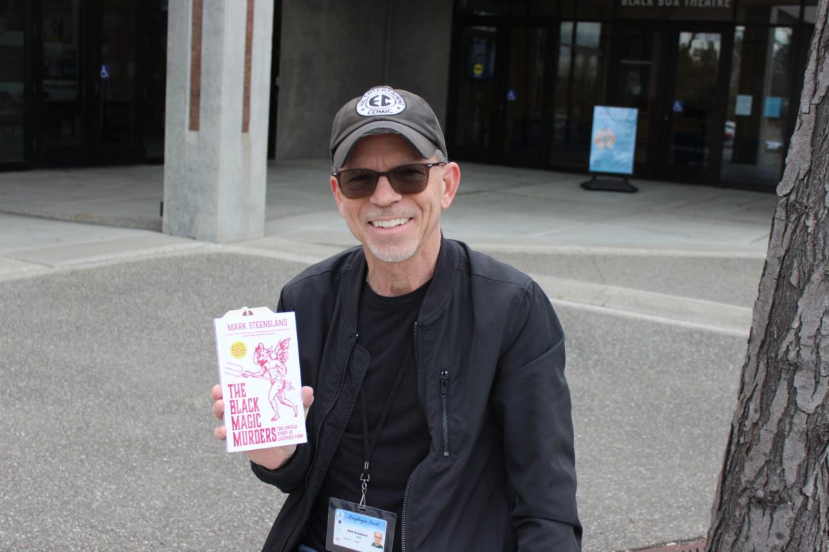 Film professor Mark Steensland displays his latest novel, “The Black Magic Murders,” in front of the Black Box Theater on Feb. 27. He will discuss the writing and publishing process as co-host at the “Writing Demystified” event on Thursday at A Seat at the Table Books in Elk Grove.
