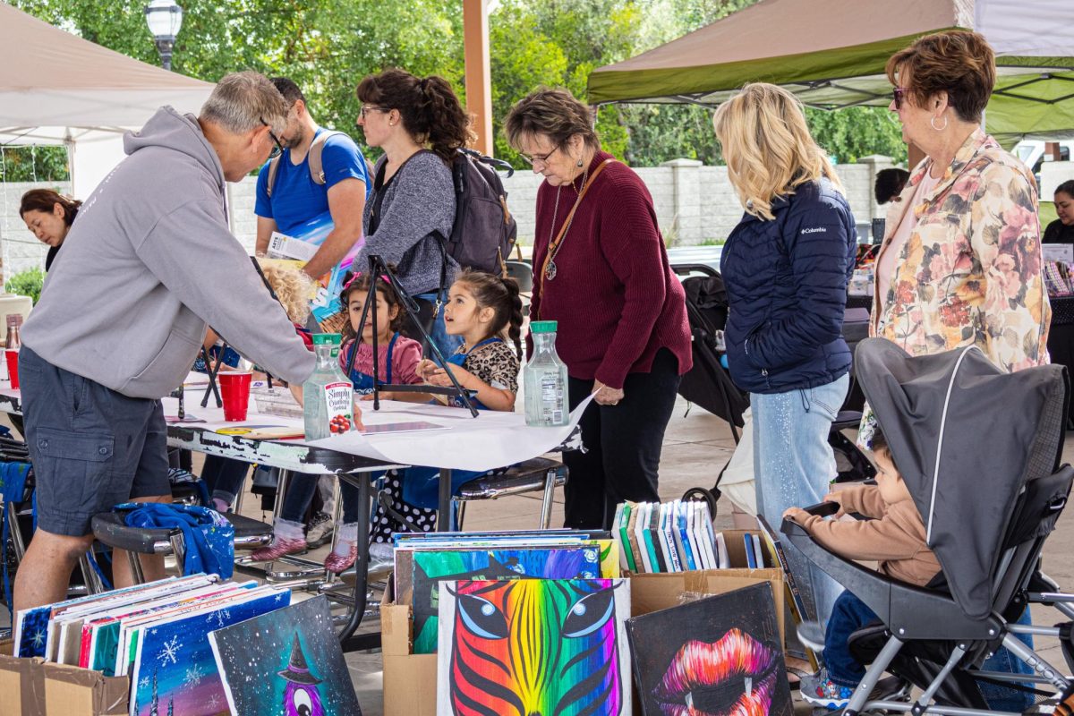 Brian Van Lente, the owner of Pinot’s Palette, helps locals and their children paint at his booth. Elk Grove’s fifth annual Festival of the Arts in the Old Town Plaza in Historic Elk Grove allowed local artists to come and show off their work on Saturday. 