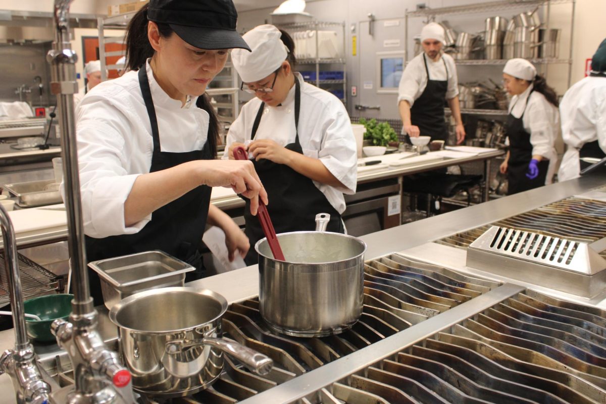 Culinary arts management students making sauces in the teaching kitchen at Cosumnes River College during their soups, stocks and sauces unit on Feb. 17. The culinary arts kitchen underwent renovations that allowed room for new equipment, spaces and opportunities.