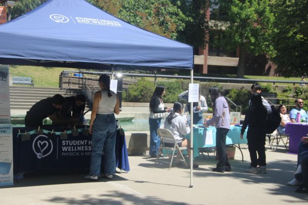 Students browse informational tables and resources during a Denim Day event at Cosumnes River College. The event, held on April 29, brought together campus and community partners to raise awareness about sexual violence and connect students with support services.
